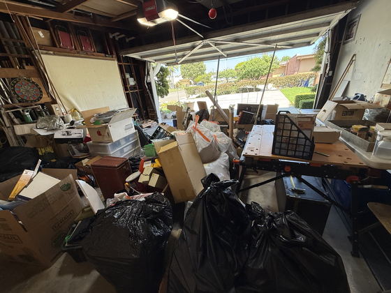 A Los Angeles County garage packed shoulder-high with cartons, bulging black bags, storage crates and tools, only a narrow path left to the open roller door